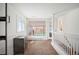 Hallway with staircase to second floor and view of backyard through large window at 4731 S Acoma St, Englewood, CO 80110
