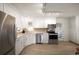 Modern kitchen featuring stainless steel appliances, white cabinets, and tiled backsplash at 4731 S Acoma St, Englewood, CO 80110