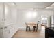 Bright kitchen area with white cabinets, track lighting and a small table with seating for two at 4731 S Acoma St, Englewood, CO 80110