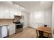 Well-lit kitchen featuring stainless steel appliances, plentiful storage, and an inviting dining area at 4731 S Acoma St, Englewood, CO 80110