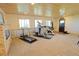 Finished basement with workout area, windows, and light brown carpet at 13525 Woodmoor West Dr, Larkspur, CO 80118