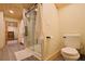 Bathroom showing a walk in shower with glass doors, neutral colors, and a wood ceiling at 13525 Woodmoor West Dr, Larkspur, CO 80118