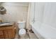 Bright bathroom features wood vanity, toilet, and bathtub at 13525 Woodmoor West Dr, Larkspur, CO 80118