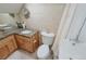 Bright bathroom features wood vanity, toilet, and bathtub at 13525 Woodmoor West Dr, Larkspur, CO 80118
