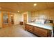 Bedroom featuring paneled walls, wood flooring, a queen bed, and ample natural light at 13525 Woodmoor West Dr, Larkspur, CO 80118