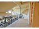 Hallway with animal themed iron railing and log beam details at 13525 Woodmoor West Dr, Larkspur, CO 80118