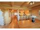 Charming log home kitchen with breakfast bar, offering a warm and inviting space for cooking and dining at 13525 Woodmoor West Dr, Larkspur, CO 80118