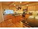 Well-equipped log home kitchen with granite countertops, stainless steel appliances, and ample cabinet space at 13525 Woodmoor West Dr, Larkspur, CO 80118