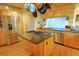 Well-lit kitchen featuring stainless steel appliances, granite countertops, and a spacious center island with cooktop at 13525 Woodmoor West Dr, Larkspur, CO 80118