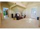 Open living space with exposed beam details and walk-out access at 13525 Woodmoor West Dr, Larkspur, CO 80118