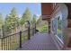 A log home featuring a covered porch with scenic views of the surrounding landscape at 13525 Woodmoor West Dr, Larkspur, CO 80118