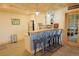 Wet bar area featuring a stainless steel refrigerator, cabinets, and modern barstools at 13525 Woodmoor West Dr, Larkspur, CO 80118