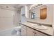 Bright bathroom featuring a vanity with drawers and a tub with shower at 655 S Alton Way # 6C, Denver, CO 80247