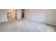 Bedroom with neutral carpeting, closet, and ensuite bathroom access at 655 S Alton Way # 6C, Denver, CO 80247