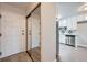 Entryway with mirror closet and kitchen view with stainless appliances at 655 S Alton Way # 6C, Denver, CO 80247