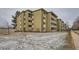 Side angle exterior view of multi-story condo building on an overcast day at 655 S Alton Way # 6C, Denver, CO 80247