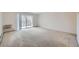 Spacious living room with neutral carpet and access to a private balcony at 655 S Alton Way # 6C, Denver, CO 80247