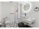 Modern bathroom with a vessel sink, LED mirror, and tiled walk-in shower at 7649 E Amherst Ave, Denver, CO 80231