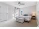 Bright bedroom with a barn-style door, neutral decor, and plenty of natural light at 7649 E Amherst Ave, Denver, CO 80231