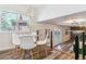 A modern dining area featuring a glass table, white chairs, and contemporary lighting fixture at 7649 E Amherst Ave, Denver, CO 80231