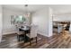 Dining room with a rustic table, upholstered chairs, and modern light fixture at 7649 E Amherst Ave, Denver, CO 80231