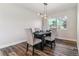Dining room featuring a rustic table with four chairs and modern light fixture at 7649 E Amherst Ave, Denver, CO 80231