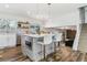 Bright kitchen featuring an island with bar seating, stainless steel appliances, and wood-look floors at 7649 E Amherst Ave, Denver, CO 80231
