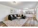 Open-concept living room with comfortable sofa, bright rug, and modern decor at 7649 E Amherst Ave, Denver, CO 80231