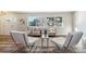 Bright living room with two white chairs, a small coffee table, and hardwood floors at 7649 E Amherst Ave, Denver, CO 80231