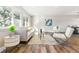 Bright living room with plenty of natural light, featuring hardwood floors and modern decor at 7649 E Amherst Ave, Denver, CO 80231
