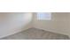 Minimalist bedroom featuring neutral tones, a window, and carpeted floors at 17325 E Rice Cir # F, Aurora, CO 80015
