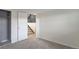 Carpeted bedroom with closet and an open doorway to a carpeted staircase at 17325 E Rice Cir # F, Aurora, CO 80015