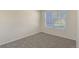 Simple bedroom featuring neutral tones, a window, and carpeted floors at 17325 E Rice Cir # F, Aurora, CO 80015
