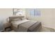 Cozy bedroom with natural light, furnished with a comfortable bed and side tables at 17325 E Rice Cir # F, Aurora, CO 80015