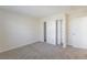This bedroom features neutral carpeting, a closet with sliding doors, and a separate door to the rest of the house at 17325 E Rice Cir # F, Aurora, CO 80015