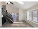 This entryway features a vaulted ceiling with skylight, staircase, a chandelier, and wood-look flooring at 17325 E Rice Cir # F, Aurora, CO 80015