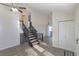 This entryway features a staircase to the upper level, a chandelier, and wood-look flooring at 17325 E Rice Cir # F, Aurora, CO 80015