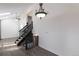 Inviting foyer featuring hardwood floors, a staircase with iron railings, and decorative lighting at 17325 E Rice Cir # F, Aurora, CO 80015
