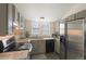 Well-lit kitchen featuring stainless steel appliances, gray cabinetry, and granite countertops at 17325 E Rice Cir # F, Aurora, CO 80015