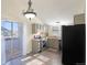 This kitchen includes updated appliances, gray cabinets, and a sliding glass door to an outdoor space at 17325 E Rice Cir # F, Aurora, CO 80015