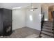 This living room features a skylight, ceiling fan, fireplace and staircase to the upper level with carpeted stairs at 17325 E Rice Cir # F, Aurora, CO 80015