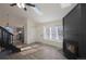 This living room features a corner fireplace, staircase, a chandelier, and wood-look flooring at 17325 E Rice Cir # F, Aurora, CO 80015