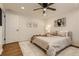 Bedroom features ceiling fan, wood floors, plush rug, and door to other rooms at 3376 Jasmine St, Denver, CO 80207