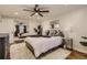 Bedroom features ceiling fan, wood floors, plush rug, and double mirror sliding closet at 3376 Jasmine St, Denver, CO 80207