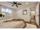 Bright bedroom with ceiling fan, light walls, plush rug, and closet for ample storage at 3376 Jasmine St, Denver, CO 80207
