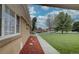 Tan brick multi-unit dwelling sits in a green manicured lawn and blue sky overhead at 3376 Jasmine St, Denver, CO 80207