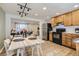Open kitchen and dining area with wood floors, modern lighting, and stainless steel refrigerator at 3376 Jasmine St, Denver, CO 80207