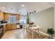 Bright eat-in kitchen features wood cabinets and laminate flooring, creating a warm and inviting atmosphere at 3376 Jasmine St, Denver, CO 80207