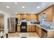 Bright kitchen features stainless steel appliances, light wood cabinets, and modern subway tile backsplash at 3376 Jasmine St, Denver, CO 80207