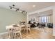 Spacious living room and dining area with wood floors, neutral paint, and large window at 3376 Jasmine St, Denver, CO 80207